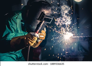 Metal welding steel works using electric arc welding machine to weld steel at factory. Metalwork manufacturing and construction maintenance service by manual skill labor concept. - Shutterstock ID 1889336635