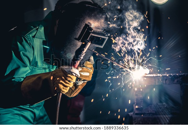 Metal\
welding steel works using electric arc welding machine to weld\
steel at factory. Metalwork manufacturing and construction\
maintenance service by manual skill labor\
concept.
