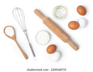 Metal whisk and eggs for cooking isolated on white