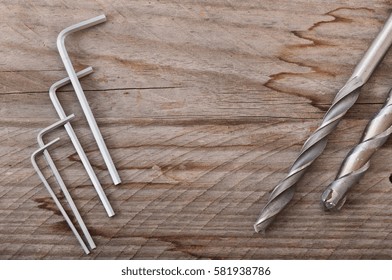 Metal work tools on the old wooden background