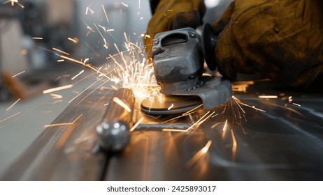 Metal worker using a grinding machine. A metal saw close-up on the sides flies with bright sparks from an angle grinder. Hot sparks when grinding steel material. - Powered by Shutterstock