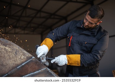 Metal worker wearing protective gear is using an angle grinder, producing a shower of sparks while smoothing a metal surface - Powered by Shutterstock