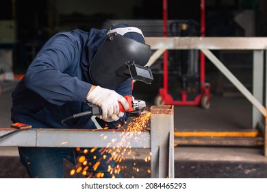 Metal workers use manual labor. Skilled welder.Technicians use steel cutting tools to cut steel. Metal cutting. Worker electric saw wheel grinding cutting
 a steel in factory.
