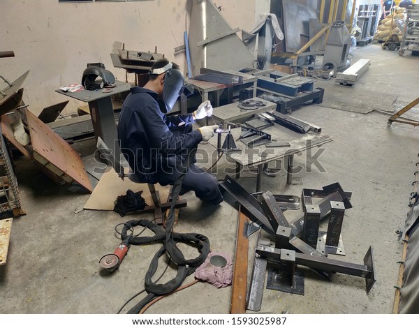 Metal\
workers use manual labor, Skilled welder, Factory workers making\
OT, The welder is welding the steel in the factory, Welding fumes,\
The welder stands to weld the iron in the\
dark.