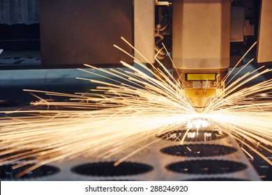 metal working. Laser cutting technology of flat sheet metal steel material processing with sparks. Authentic shooting in challenging conditions. Maybe little blurred.
