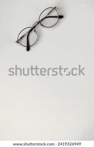  metal-framed glasses on a light background. free space for text. photo from above