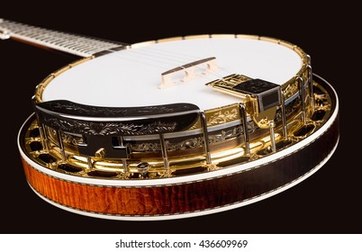 Metalic luxury golden banjo  on black background.