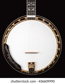 Metalic luxury golden banjo  on black background.