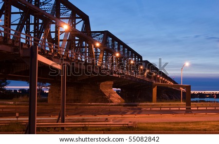 Metallic Bridge Structure over the highway at Dusk