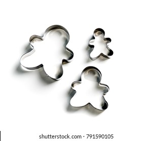 Metallic Christmas cookie cutters set on white background.