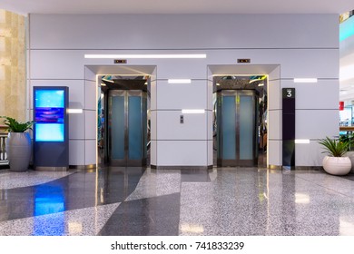 Metallic Doorway Of Modern Elevator In Office Building, Architecture Contemporary Of Door Lift And Interior Lighting Decorative. Electronic Control Panel And Flooring Symbol Signage Of Elevator