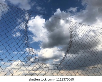 Metallic fence with a hole. Freedom and security background. Protection - Shutterstock ID 1112375060
