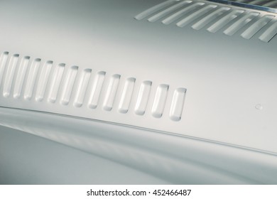 Metallic Grey Modern Of The Retro Futuristic Racing Car Detail. Air Intake Gills. Automotive Fan Minimalistic Wallpaper. Vintage Effect. 

