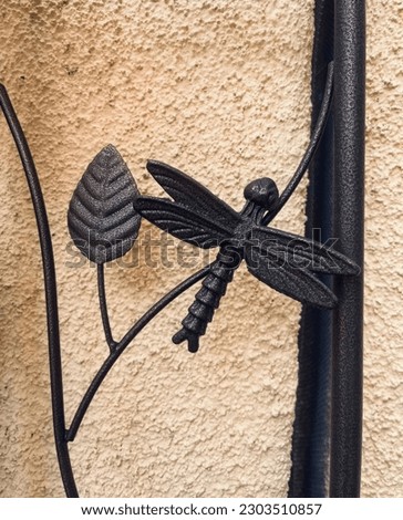 Metallic leaf and dragonfly sculpture