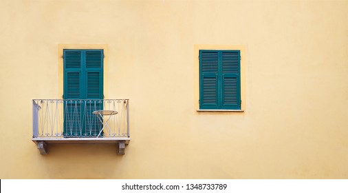 Metallic Lilac Balcony With Green Sash Door And Wooden Window With Shutters In Orange Frame On Yellow Wall