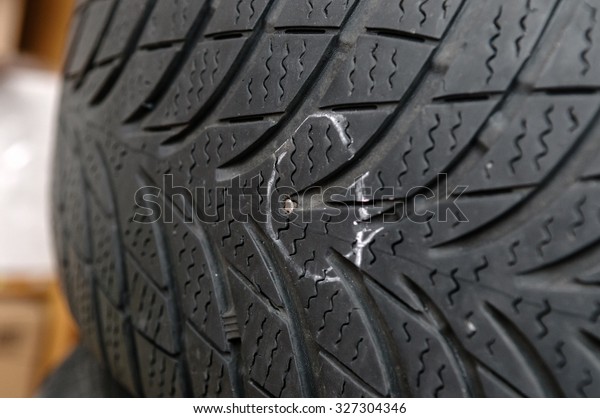 metallic nail in\
damaged tyre before\
repair