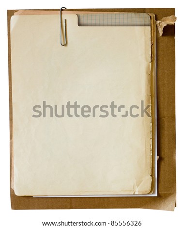 Metallic paper clip on stack of old papers. Clipping path included