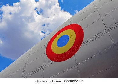 Metallic Rivets Texture Closeup On The Fuselage Of A White Aircraft And A Circular Romanian Army Flag Symbol On A Blue Summer Sky Background
