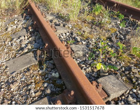 Metallic rusted railroad railway track of train abandoned, forgotten and not used any more for transportation.