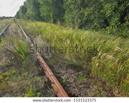Metallic rusted railroad railway track of train abandoned, forgotten and not used any more for transportation.