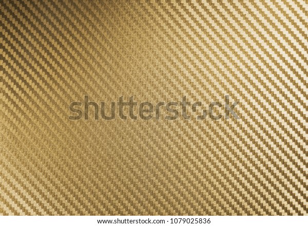Metallic shiny texture of gold\
carbon fiber self-adhesive paper. Material for racing car\
modification. Material design for background, wallpaper, graphic\
design