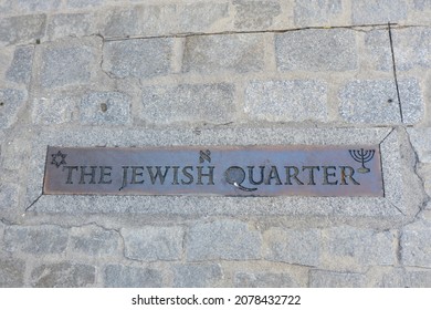 Metallic sign of jewish quarter written in english language outside on the street in multi cultural historical city of Toledo, Spain