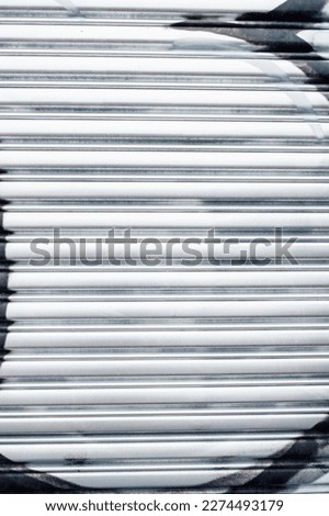 metallic silver painted corrugated metal garage door with hint of graffiti