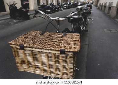 A Metallic Silver  Retro Bicycle With A Beautiful Wicker Basket Standing On A Street, Europe Concept, Selective Focus. Top View. 