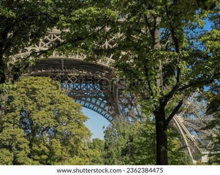 Similar – Eiffel Tower in green trees on blue sky