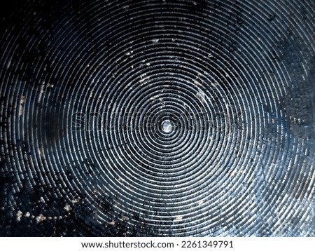 Metallic surface concentric circle pattern background.