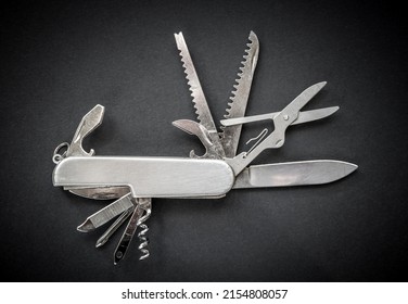 Metallic swiss knife isolated on black background