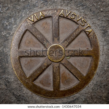 metallic symbol of the Via Augusta on the floor