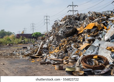 Metallic Waste Solution Dump Pile In The Yard Of A Factory With Big Furnace And Processing Unit In The Background