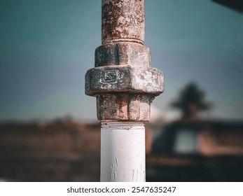 A metallic water pipe captured in sharp focus with a bokeh effect, showcasing its reflective surface against a dreamy, blurred background of soft, glowing lights.

 - Powered by Shutterstock