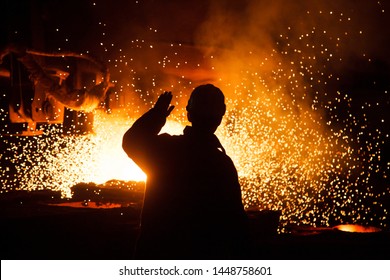 Metallurgist at casting ingot. Foundry Shop, Metallurgical production. - Powered by Shutterstock