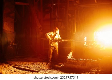 Metallurgists taking samples of liquid molten metal. - Powered by Shutterstock