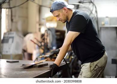 Metalwork Craftsman Making Handmade Lamp At Workshop. Man Worker Is Welding With Gas Welder Unit Of Parts Of Lampshade. Do It Yourself. Small Local Business.