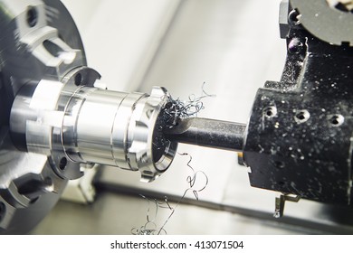 metalwork industry. multi cutting tool cnc machine pefroming technology counterboring and drilling metal detail on lathe at factory. Toned