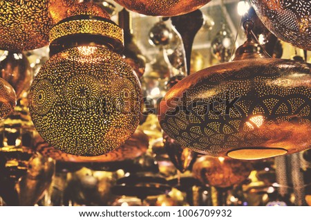 Metalwork lampshades hanging outside a shop in a Marrakesh souk