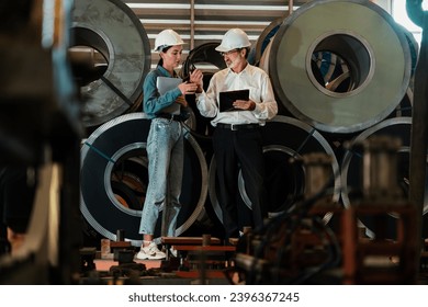 Metalwork manufacturing factory manager inspect newly manufactured metal or steel roll and frame in factory. Inspection and quality control process ensure highest quality product. Exemplifying - Shutterstock ID 2396367245