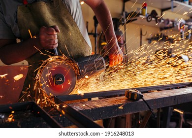 metalworker cutting steel with circular saw 