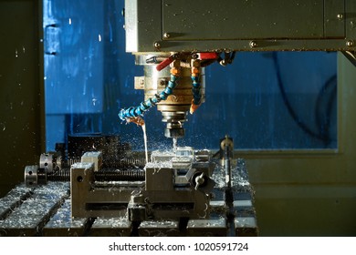 Metalworking CNC milling machine. Cutting metal modern processing technology.Milling metalworking process. Industrial high precision CNC metal machining by vertical mill.  