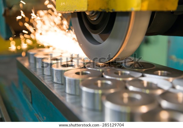 metalworking industry:\
finishing metal working on horizontal surface grinder machine with\
flying sparks