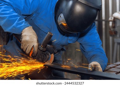 In metalworking, locksmith wears special goggles while using an angle grinder to generate sparks - Powered by Shutterstock