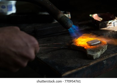 Metalworking with a piece of metal and strong fire. - Powered by Shutterstock