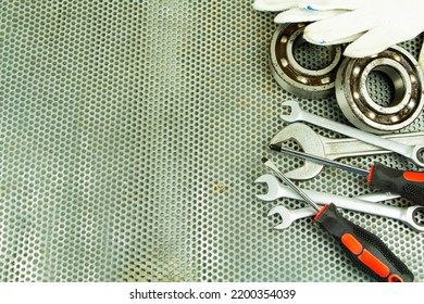 Metalworking Tools, Steel Parts, A Wrench, On The Background Of A Metal Lattice.