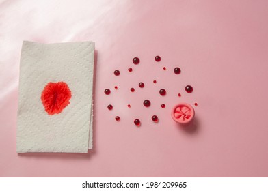 Metaphor of the anus on a pink background. Blood drops, the concept of rectal bleeding, awareness of hemorrhoids, rectal cancer, proctology. High quality photos.