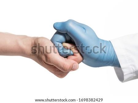 Metaphor of doctor care. Hand of doctor in blue latex glove is embraces the hand of patient. Isolated on white.