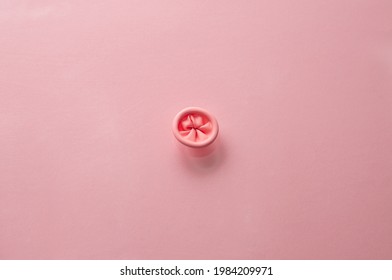 Metaphor image of the anus on a pink background. Rectal health, anus hygiene. Proctology, prevention of hemorrhoids, awareness of rectal diseases. High quality photo. 
