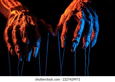 Metaphorical paws of the devil with threads for control